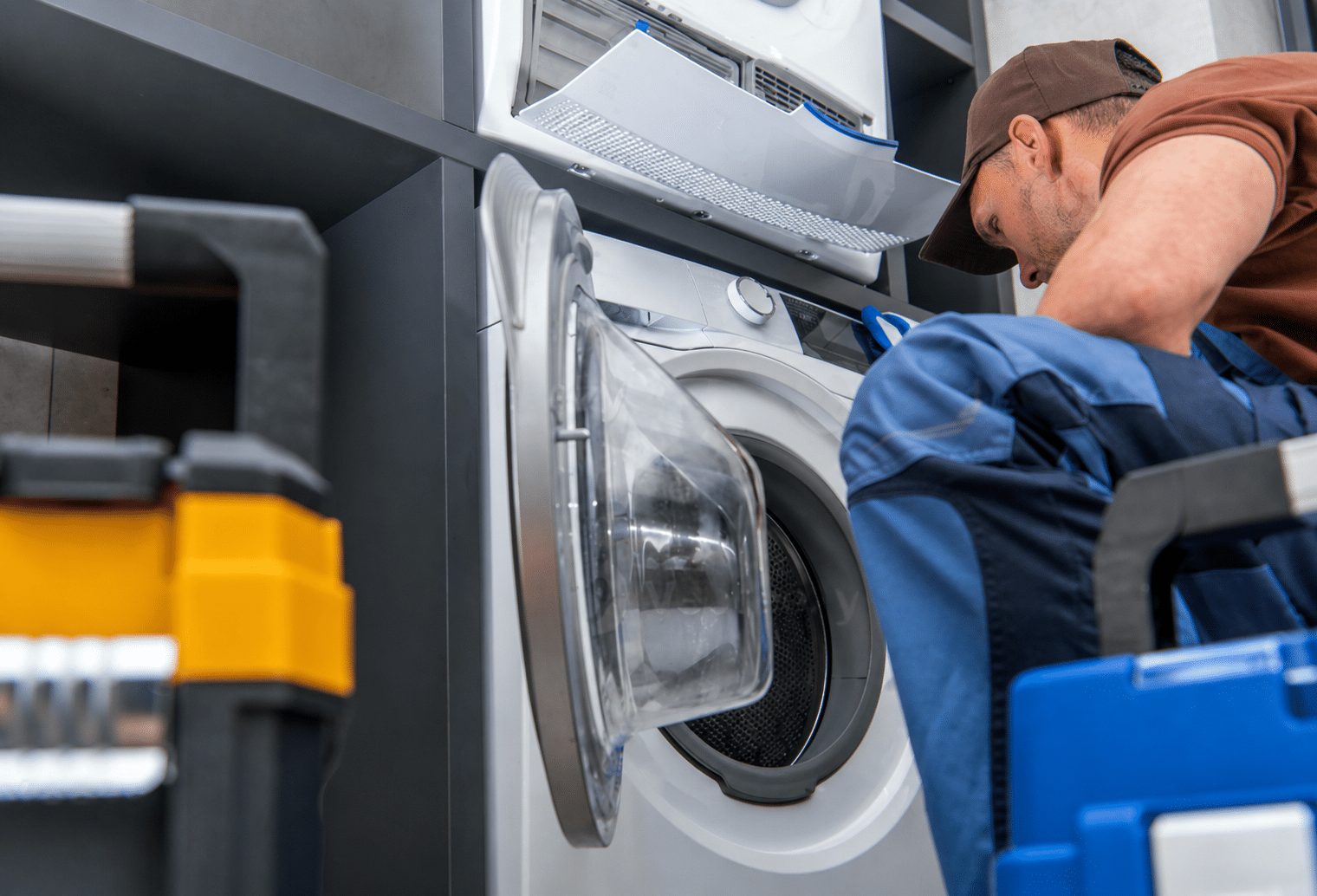 Commercial laundry equipment installation engineer servicing a commercial washing machine